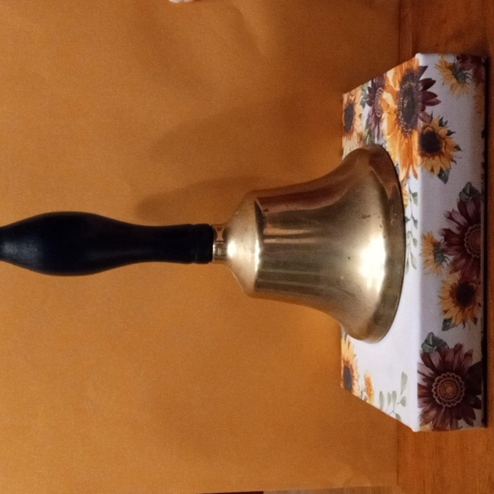 Brass bell with black handle